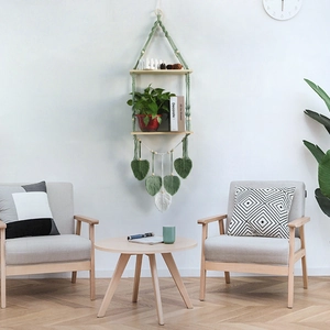 Bohemian woven wall hanging shelf with wood boards and green leaf macrame tassels