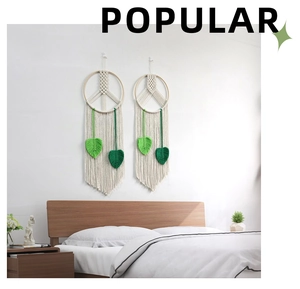 Detailed macro view of woven macrame peace sign wall hanging with green leaf fringe