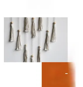 Detail of bohemian handmade woven wall hanging with white cotton cords and wooden beads