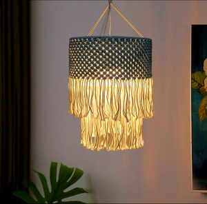Detail of bohemian macrame lampshade with blue woven top and white double-layered fringe