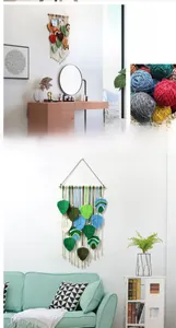 Detail of bohemian hand-woven leaf macrame wall hanging with wooden rod and cotton yarn
