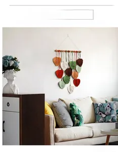 Detailed boho macrame wall hanging with handmade leaf tassels and cotton woven texture