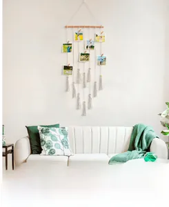 Detail view of Bohemian photo display hanger with wooden clips and macrame cotton tassels