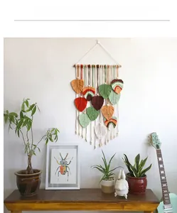 Detail of bohemian hand-woven leaf macrame wall hanging in warm earth tones