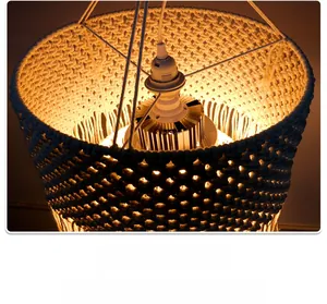 Macro view of macrame lampshade with geometric woven patterns and a warm LED light source