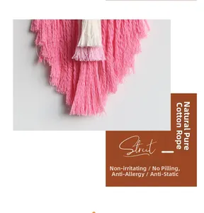 Detail of multi-color cotton fringe on bohemian heart tapestry with gradient pink layers