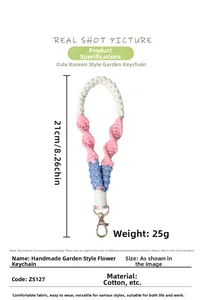 Detail view of 21cm handmade cotton flower braid keychain with silver lobster clasp