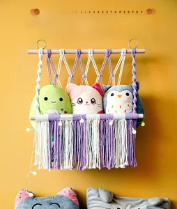 Detail of bohemian purple woven tassel tapestry for toy storage with wood support