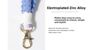 Detail of hand-woven cord strap featuring a gold electroplated zinc alloy lobster clasp