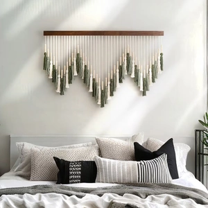 Close-up of woven macrame wall hanging with cotton tassels and wooden beads decor