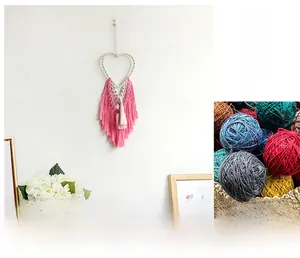 Detail of handmade bohemian heart woven tapestry with pink fringe and cotton rope
