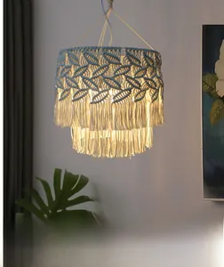 Detail of bohemian macrame lamp shade with intricate leaf weave and long fringe tassels