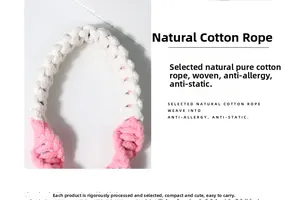 Detailed macro view of pink and white hand-woven cotton lanyard with braided texture