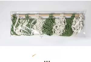 Detail of hand-woven green and white cotton storage net with dimensions and wooden rod