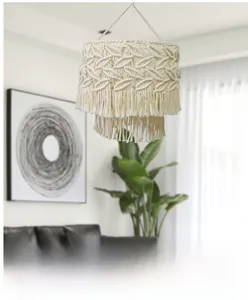 Detailed macro view of the ivory woven cotton macrame lamp shade with layered fringe accents