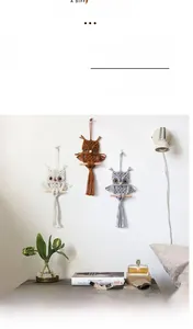 Detail of owl macrame wall hangings in beige, brown and grey with wood support