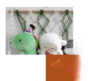 Detail of hand-woven cotton macrame storage net with wooden rod for kids room decor
