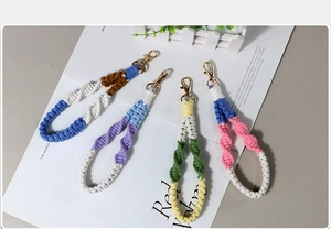 Macro detail of handmade macrame keychains with colorful weaving and gold lobster clasps