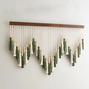 Handmade boho macrame wall hanging with sage green tassels and wood beads for home decor