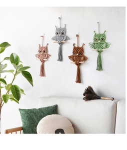 Detailed macro view of four colorful handmade macrame owl wall hangings in boho style