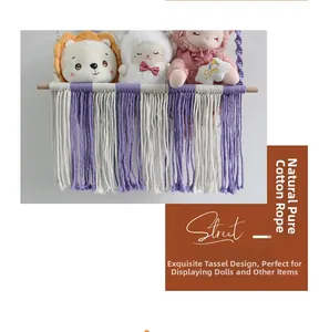 Detail view of handmade macrame toy hammock with purple cotton rope and wooden bar