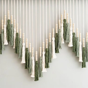 Handmade boho tassel wall hanging with wood beads in cream and green shades
