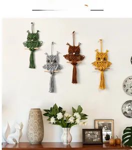 Detailed view of four handmade macrame owl wall hangings in various bohemian colors