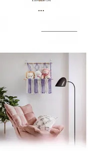Detail of hand-woven macrame toy storage hammock with purple tassels and plush animals