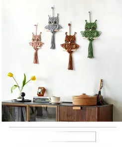 Detailed view of handcrafted owl macrame wall hangings in pink, gray, brown, and green tones