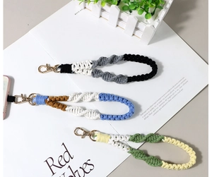 Macro view of handmade braided cotton lanyards in three colors with gold lobster clasps
