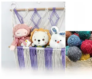 Detail of handmade purple macrame storage net with plush toys for wall decor