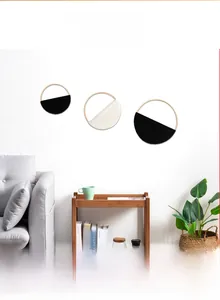 Detail of three-piece bohemian macrame wall hangings on bamboo rings in a modern interior