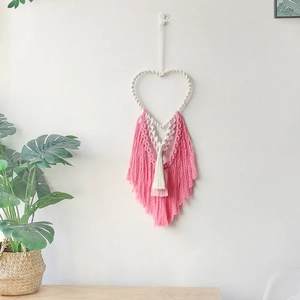 Bohemian macrame heart wall hanging with pink and white layered tassels for room decor