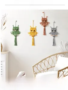 Detailed view of handmade macrame owl wall hangings in multiple bohemian colors