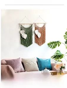 Detail of bohemian handmade woven leaf tapestry with cotton tassels and wood beads decor