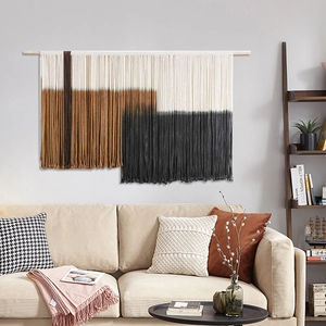 Detailed view of hand-woven cotton bohemian tapestry with geometric colors and tassels