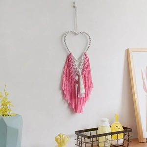 Bohemian handmade macrame heart wall hanging with pink fringe for home decor