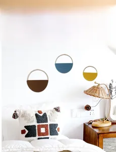 Three-piece bohemian woven wall hanging set with wooden rings in a cozy bedroom