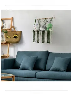Detail view of Bohemian woven storage net with tassels holding plush toys on a wall