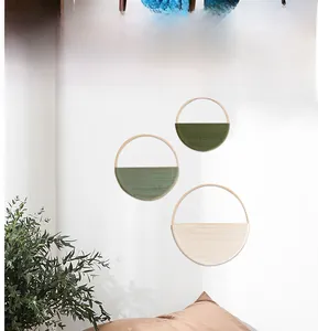Detailed trio of woven macrame wall hangings in dark green, light green, and cream white