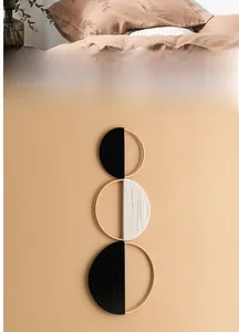 Detail of three-tier bohemian bamboo wall hanging with black and white woven fibers