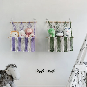 Handmade woven cotton rope toy storage net with wooden rod and fringe for kids room
