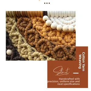 Detail of bohemian woven wall hanging with tiered cotton fringe and wooden beads