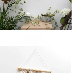 Detail of bohemian handmade woven cotton wall hanging with wood beads and fringe tassels