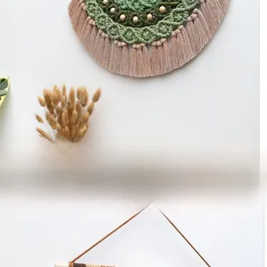 Detail of bohemian woven wall hanging with gradient cotton rope, wood beads and tassels