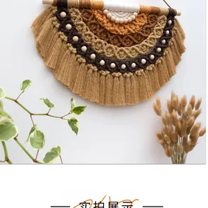 Detail of bohemian layered woven wall tapestry with cotton fringe and wood beads