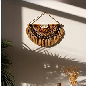 Detailed handmade macrame wall hanging with earth-tone gradient fringe and wooden rod