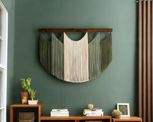 Close-up of bohemian hand-woven tapestry with green cotton tassels on a dark wood bar