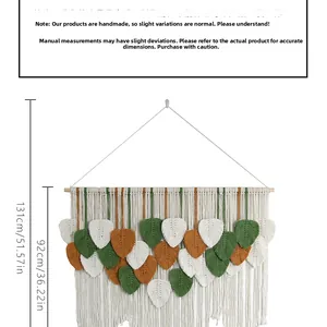 Detail of macrame wall hanging showing layered tassels and colorful leaf ornaments