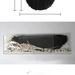 Detail showing the dimensions and packaging of a handmade black macrame wall hanging